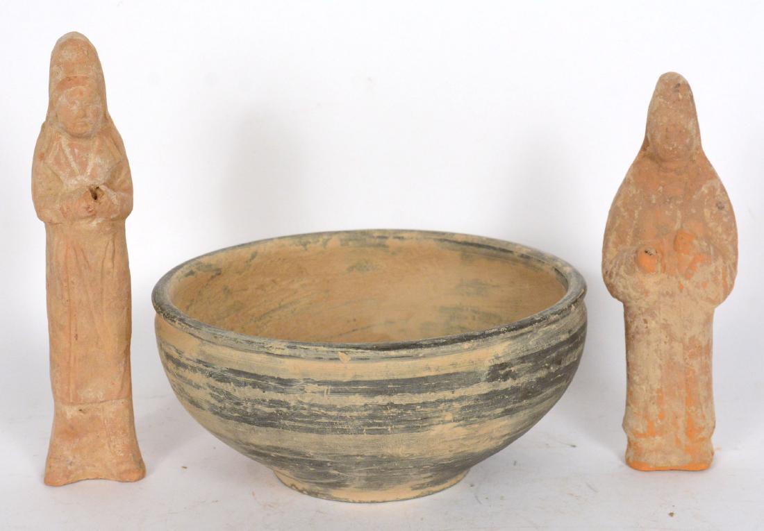 Two Chinese Han Pottery Figures: Together with a Chinese Han green and gray pottery bowl. 7 5/8"h and 9 1/4"h Provenance: Property from the Collection of Dr. Andrew and Ziva Dahl.