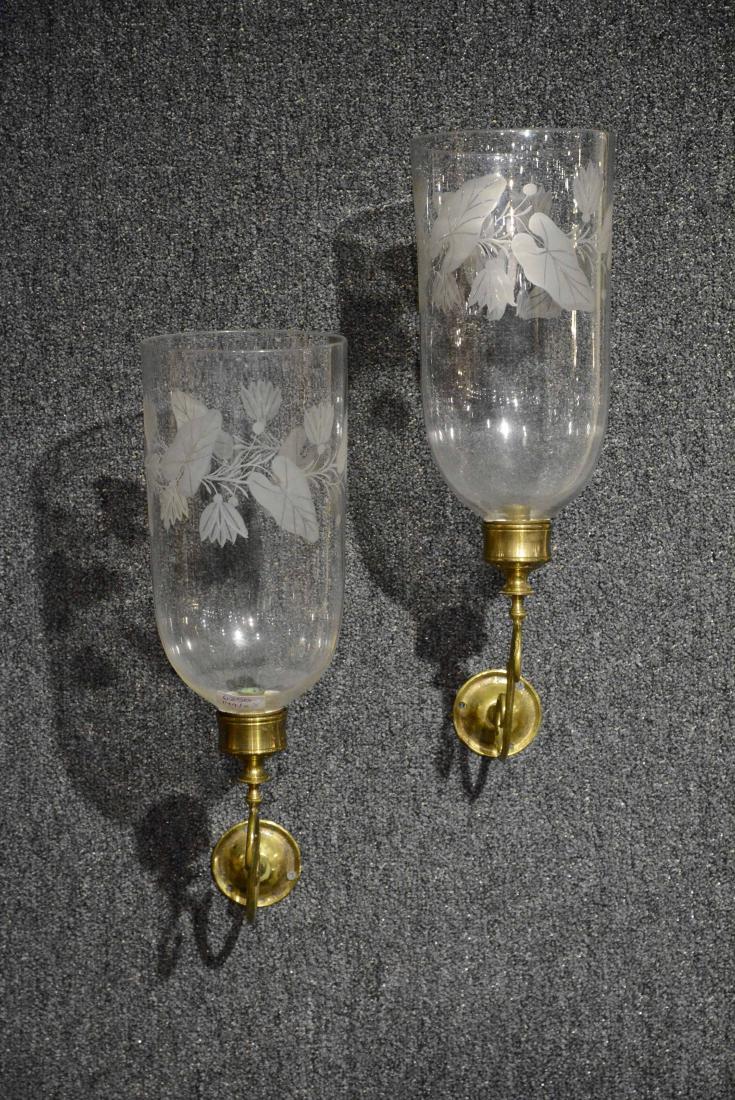 Pair of George III Brass Wall Sconces: Together with two leaf etched glass hurricane shades. 7 1/2"g x 9 1/2"w, glass shade 13"h Provenance: Mr. & Mrs. Jerome W. Blum, Lisbon, CT. Property from the Collection of Dr. Andrew and Ziva Dahl.