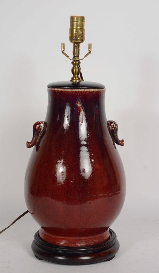 Chinese Sang de Boef Vase: With elephant handles. Electrified and fitted as table lamp. Vase 13 1/2 Provenance: Property from the Collection of Dr. Andrew and Ziva Dahl.