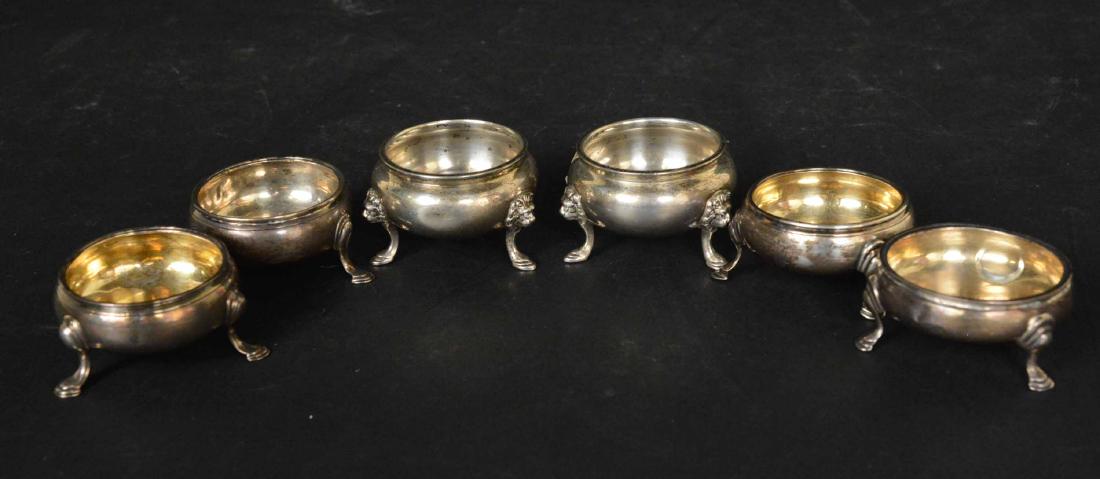 Pair of JE Caldwell Sterling Silver Salt: Cellars, lion mask and hoof feet. Together with two pair of English Georgian silver footed salt cellars, hallmarked, London, 1767, London, 1763, total weight approx.7 T.O. 2-1/4"d- 2-1/2"d. Provenance