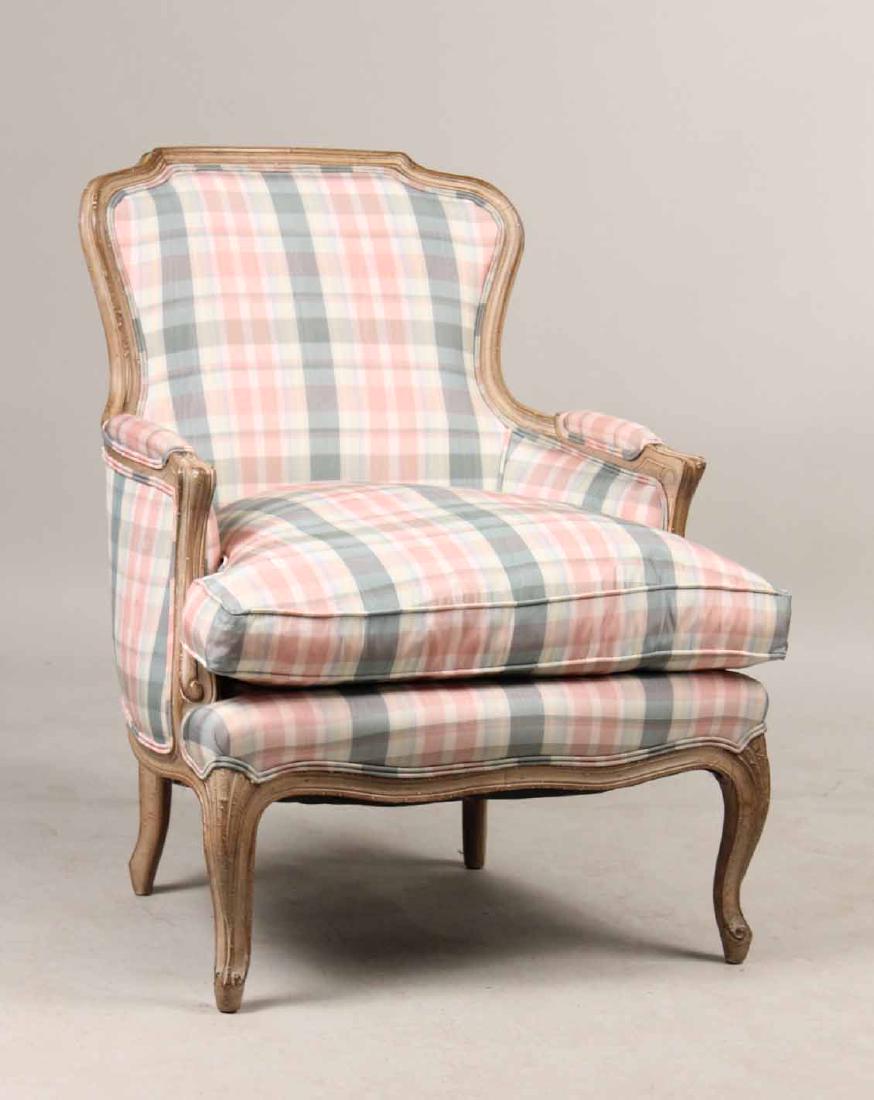 Louis XIV Style White-Painted Bergere: 20th C., with blue and pink upholstery. 34"h x 28"w Provenance: Property from the Collection of Dr. Andrew and Ziva Dahl.