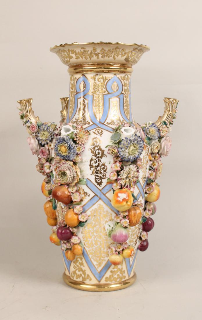Continental Floral Encrusted Centerpiece: Floral vase, surrounded by six candleholders, three broken off, fruit and floral decoration. 18-1/2"h.