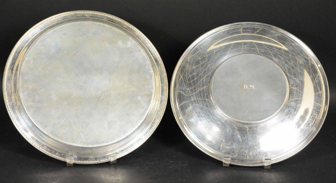 Two Circular Sterling Silver Trays: Comprising Gorham with gadrooned edge, and Tuttle with molded border, monogram on underside, total weight approx. 45 T.O. 14"d, 13"d. respectively.