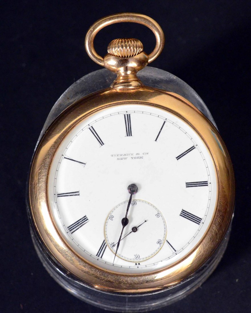 Early Tiffany & Co 18K Yellow Gold Pocket Watch: Open face pocket watch, double-sunk subsidiary second hand, porcelain dial, Roman Numerals, blued steel hands, serial number 16754, triple signed, exhibition back dust cover, engraved inside rear cove