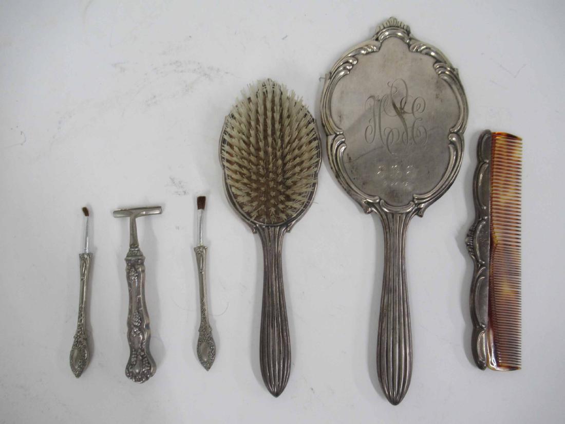 International Sterling Vanity Set: Comprising, a comb, brush, and mirror. Together with a silver plate razor and two makeup brushes. 6 pieces Mirror: 12-3/4"l