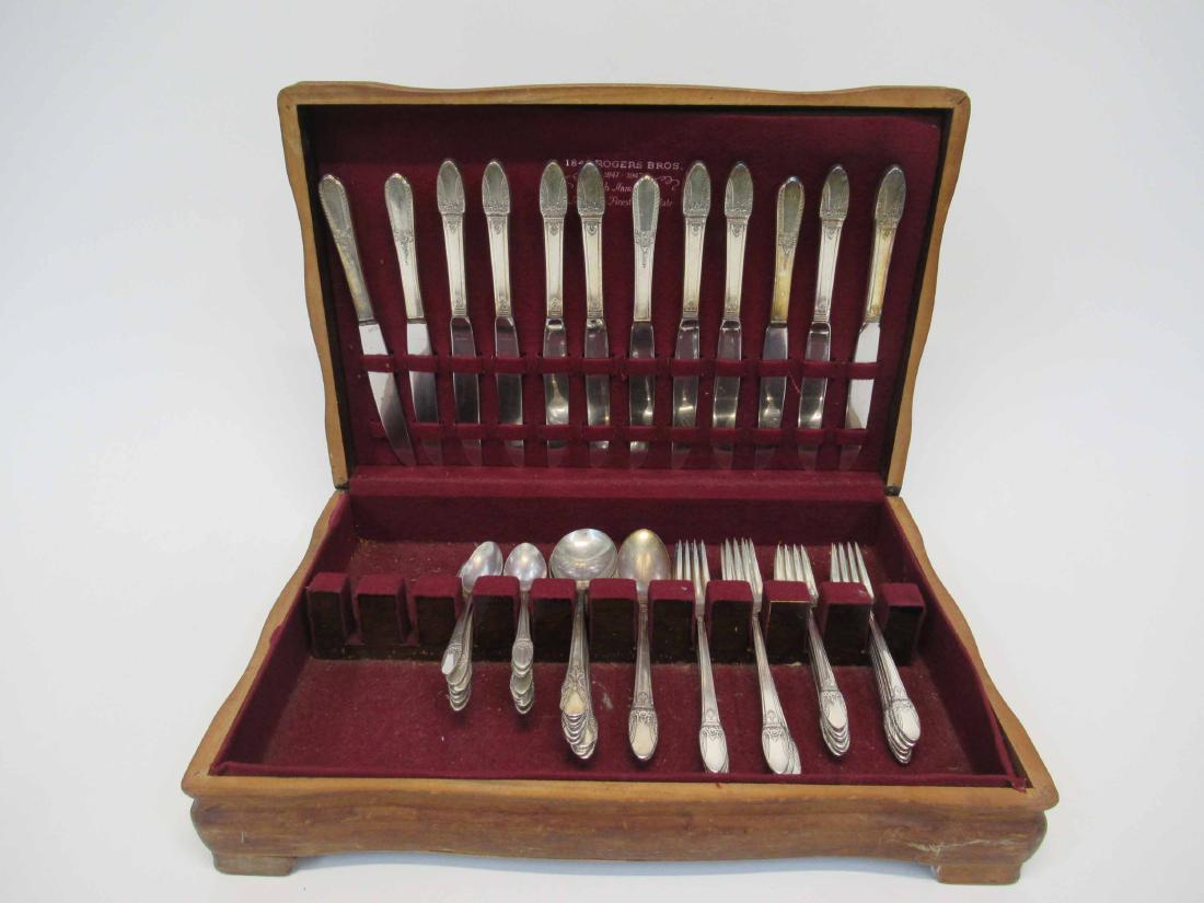 Art Deco Silver Plate Flatware: Rogers Bros. "First Love", pattern (c.1937)comprising: eight dinner forks and knives, twelve luncheon forks, ten soup spoons, two place spoons, fifteen teaspoons, and four luncheon knives.