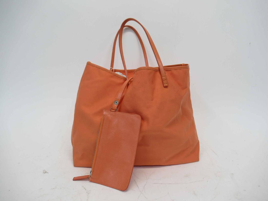 Fendi, Made in Italy Orange Neoprene Tote Bag: With matching leather trip and leather attached by strap pouch, unlined. 11"h x 18"w x 5-1/2"d, handles with 7-1/2"drop. Fendi, Sakes Fifth Avenue, New York.