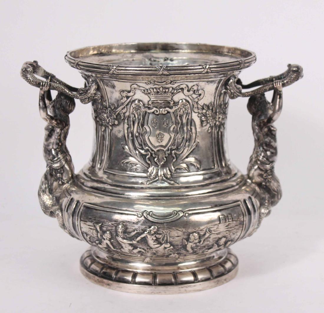 Continental Silver Elaborately Chased Loving Cup: Double handled, each handle being held up mermaid figure, reeded rim, cartouches on each side with crowned and laurel wreath framed fleur-de-lis decoration, paneled, floral motif swags, lower half of 