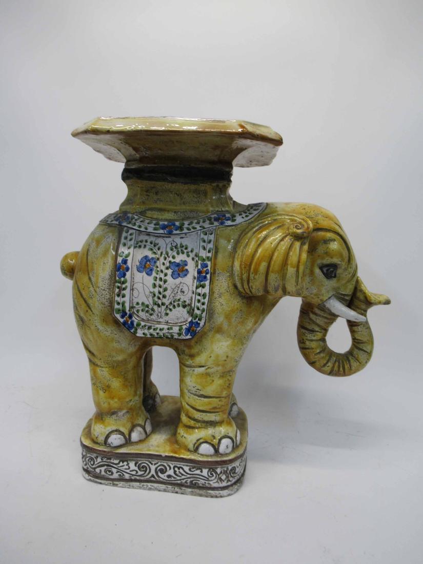 Earthenware Elephant Table: Probably terracotta. With yellow and floral decorated elephant. 22 1/2" tall x 22 1/2" long x 9 1/2" wide. Used, wear, worn.