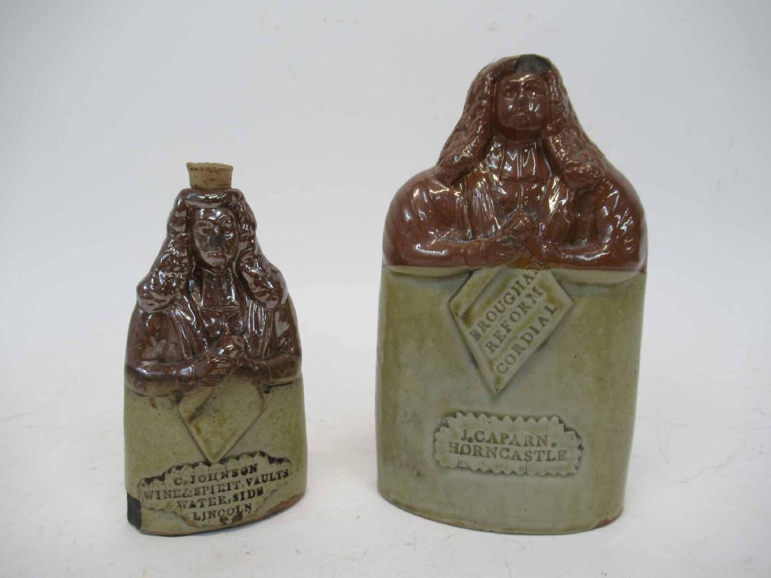 2 Oldfield Earthenware Flask: Larger Flask, Brougham Reform Cordial, J.Caparn. Horncastle. and smaller flask, C. Johnson Wine and Spirit Vaults, Water Side, Lincoln. Chips, broken stopper. Tallest 8" tall, Smallest 5 3/4" tall