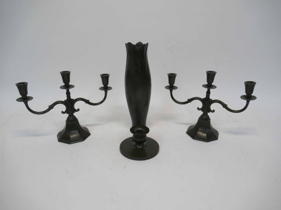 Pair of Denmark Just Andersen Candelabrum: Each having three candle holders. Together with a trench art style vase, and short candlestick. Some surface distress. candelabrum 11 3/4" long x 9" tall
