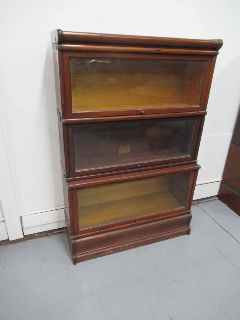 Globe Wernicke Sectional Stacking Bookcase: Mahogany 5 piece lawyers bookcases. Larger base bookcase below two smaller bookcases. Used condition, wear, worn, scratches. together size 51" tall x 34" wide x 12 1/2" deep at base