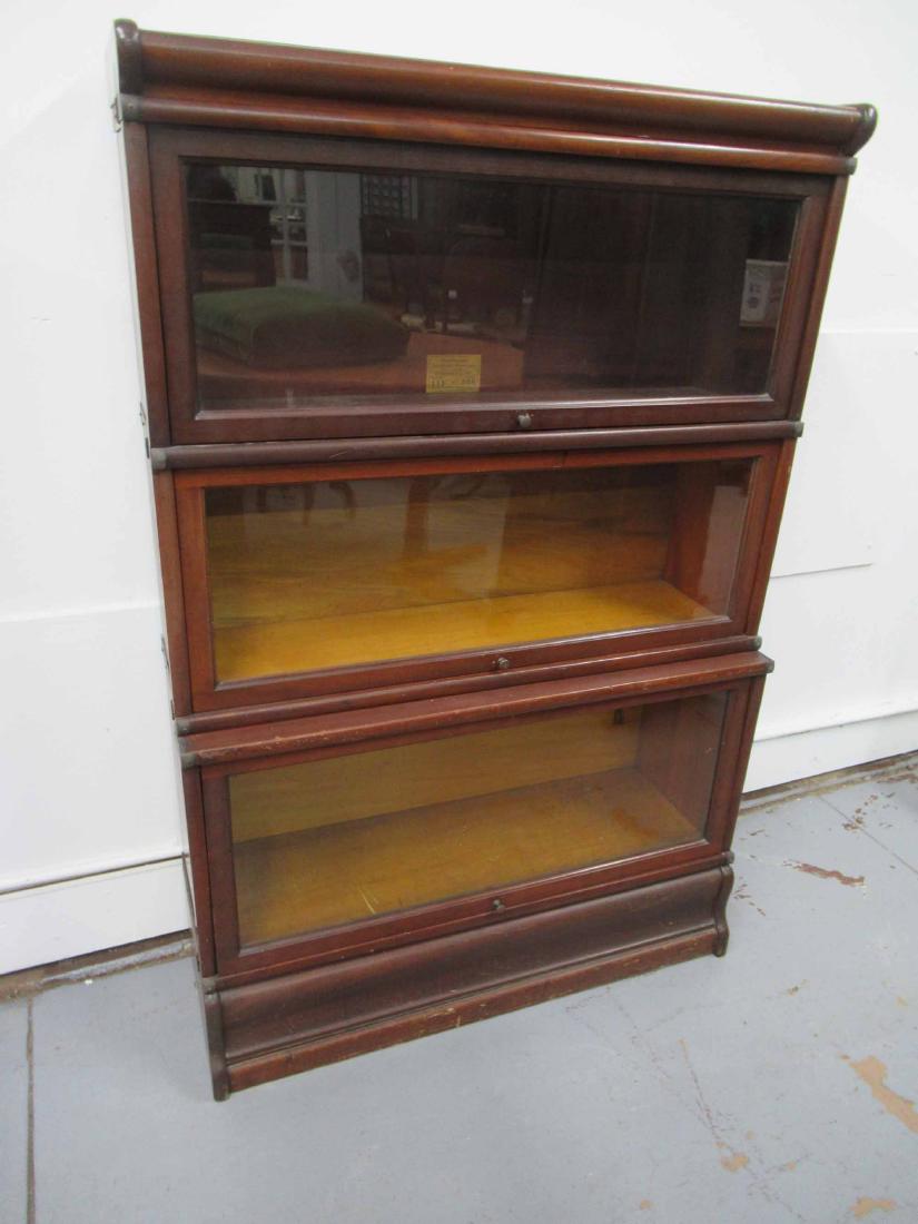 Globe Wernicke Sectional Stacking Bookcase: Mahogany 5 piece lawyers bookcases. Larger base bookcase below two smaller bookcases. Used condition, wear, worn, scratches. together size 51" tall x 34" wide x 12 1/2" deep at base