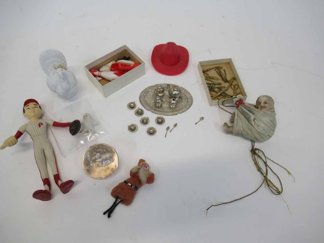 Snow Baby and Cotton Santa: Together with a group of Intercast miniature tools, a silver metal miniature tea set, barbie shoes, a "stork" baby in a blanket, a turkey, a rubber toy hat, and a rubber bendy baseball player, and a g