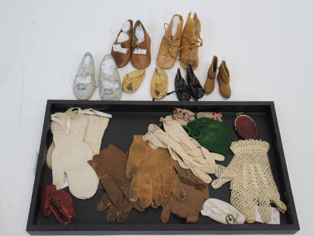 Two Pairs of Child's Kid Gloves: Together with child's silk gloves and doll gloves, a penny purse, a green doll's purse, and seven pairs of doll shoes in various sizes. Wear. losses and repairs. 3"l