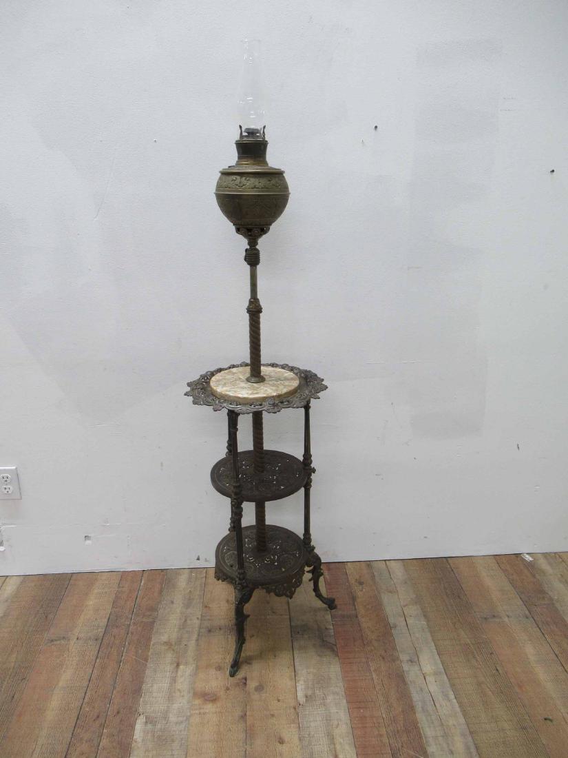 Victorian Piano Lamp: Having antique B & H brass font, resting in adjustable arm mounted to a marble and patinated metal 3 tier base with hoof feet. Used condition, wear, worn. closed size 58" tall to top of chimney x 16"