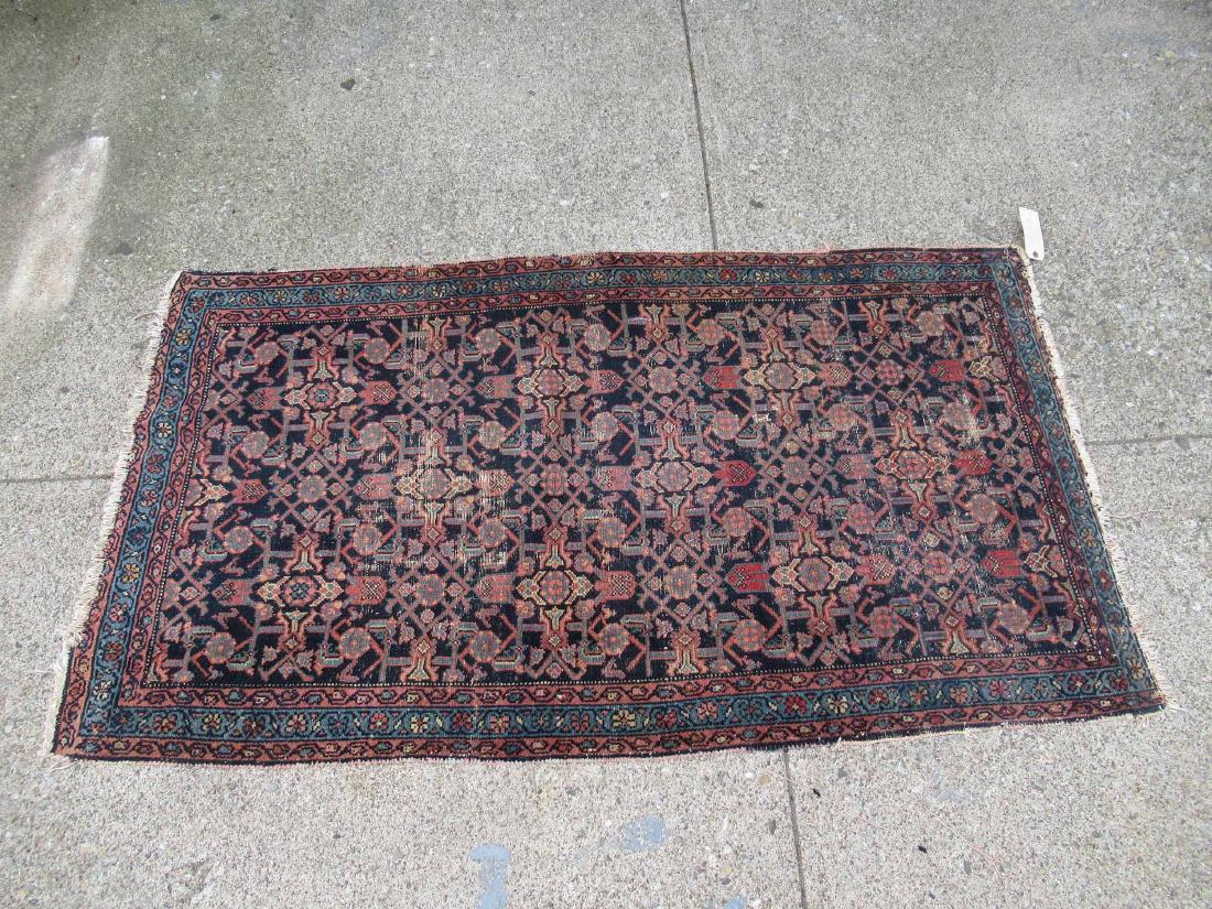 Oriental Style Throw Rug: With central blue ground and all over geometric design. Used condition, wear to fringe, holes. 73" x 41"