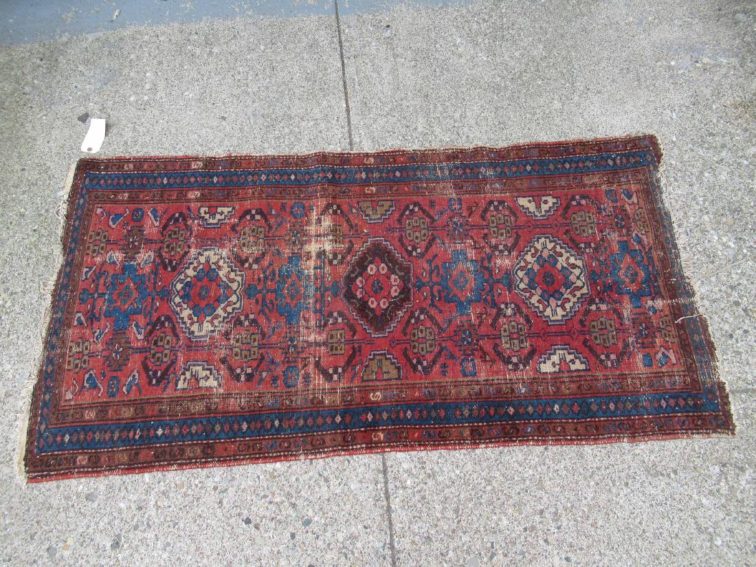 Caucasian Throw Rug: Red central ground with all over geometric and animal design. Wear throughout, fringe loss. 70" x 36"