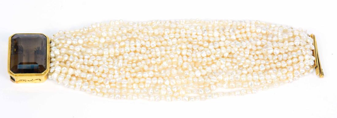 14K Yellow Gold Citrine Clasp Pearl Bracelet: Twenty four freshwater rice pearl bracelet, 14K yellow gold clasp set with emerald cut citrine, weighing approx. 35 carats, 8"l x 1-3/4"w.