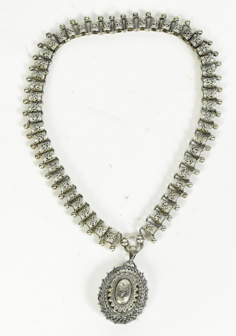 English Silver Oval Locket on Ornate Looped Chain: Late 19th/Early 20th C., hallmarked illegible makers mark, Birmingham, intricate linked chain, total gross weight approx. 43.35dwts, locket, 2-1/2"l, chain, 18"l x 5/8"w.