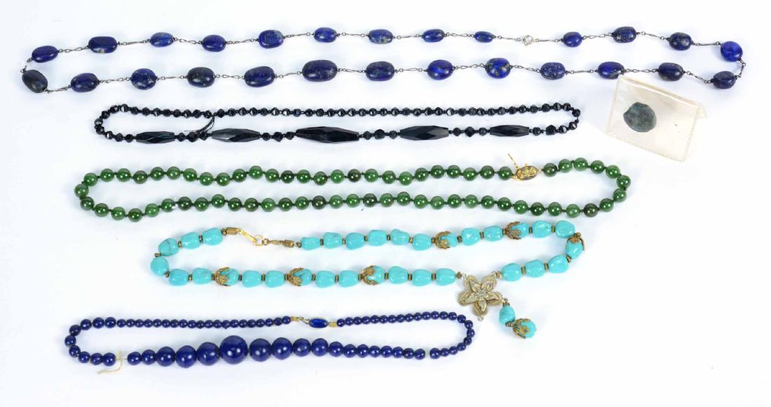 Jade Beaded Necklace: With gilt sterling silver Chinese character decorated clasp, 24"l. Together with antiquity beaded necklace, 16"l and stone coin, and a lapis lazuli graduated beaded necklace, a jet beaded necklace, an