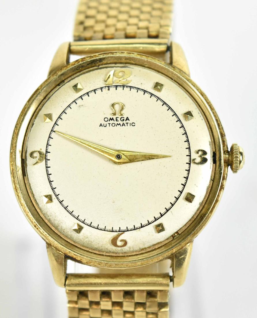 Omega 14K Yellow Gold Wristwatch on Bracelet Band: Silvered face with gilt Arabic Numeral at 12,3,6,9 and gilt numeral indicators, 30mm.