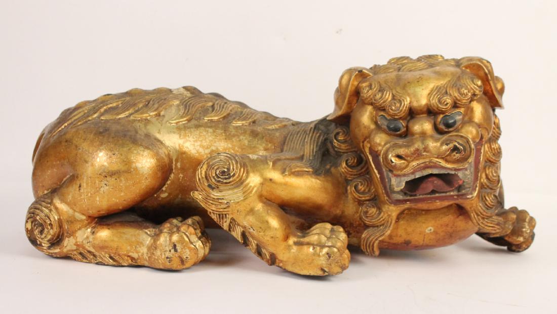Chinese Giltwood Carved Reclining Fu Dog: 19th C. Repairs and cracks. 11"h x 28"w