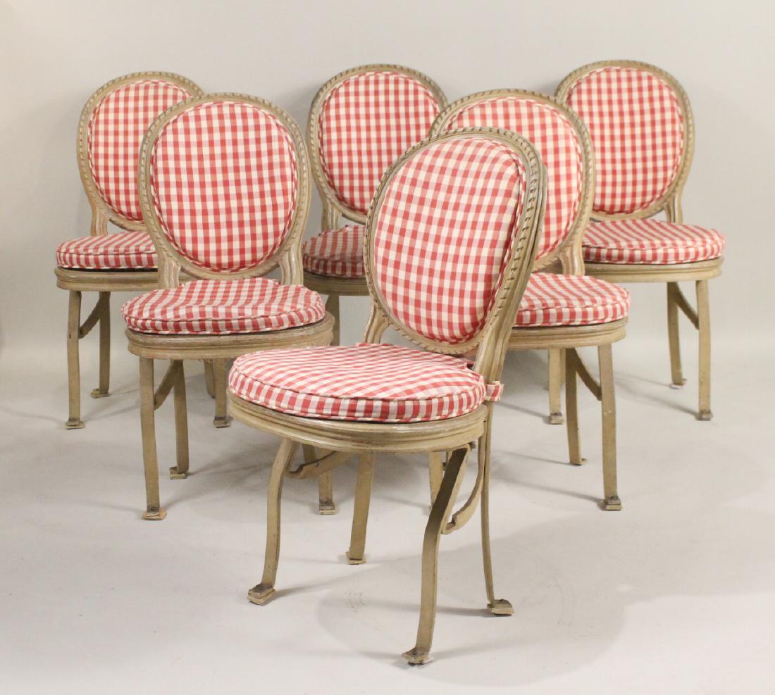 Six White-Painted Wood-and-Metal Theater Chairs: French, 19th/20th C., with hinged caned seats. Some caned seats with losses. 35-3/4"h x 18"w x 18"d