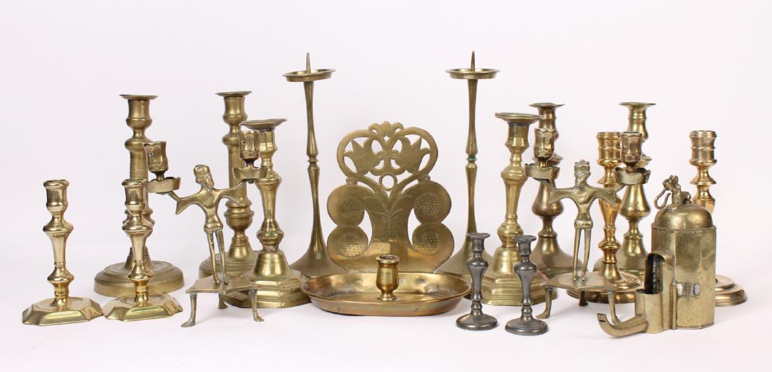 Group of Brass Candlesticks: Including a Dutch wall sconce, English Queen Anne and push up mechanisms, French Empire and Louis XIV, Dutch, figural, oil lamps and pricket sticks. Together with a pair of pewter candle sticks. 18 pi
