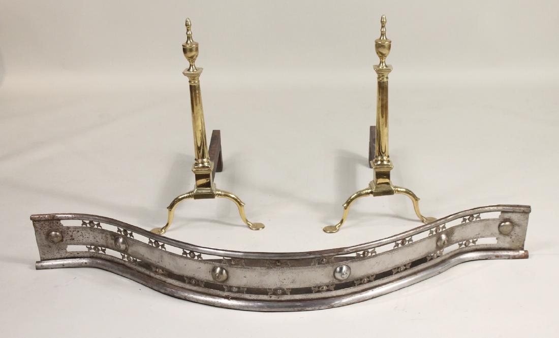 Pair of Federal Cast Brass Andirons: Together with a Steel serpentine fireplace fender, English, 19th C. 26"h