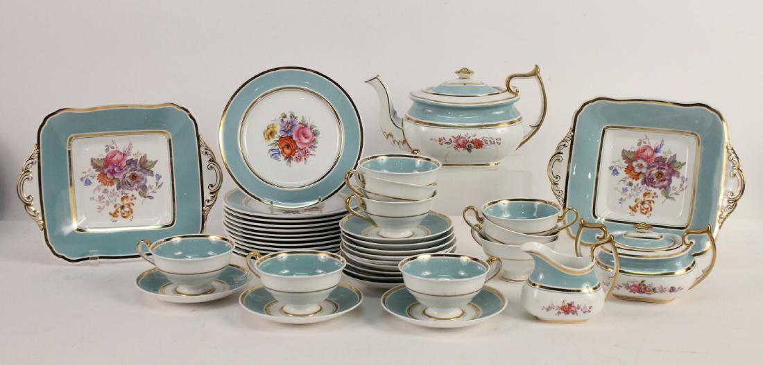Spode Copeland Porcelain Dessert Service: Retailed by Tiffany & Co. With power blue rim edge with gilt lines, the center with a floral spray, green printed mark and retailer cartouche, numbered Y5065 in red. Comprising twelve dessert plates, 