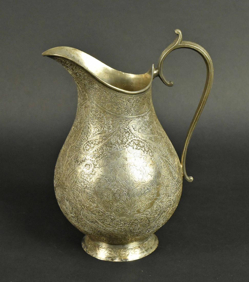 Persian Silver Pitcher: Early 20th Century, baluster form, engraved with paisley and dense flowers, apparently unmarked, 8-1/2"h, weight approx. 19 T.O. Provenance: Property from the Collection of Myrna and Bernard Posner Pu