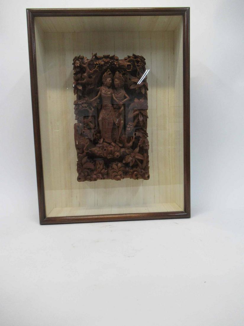 Thai Wood Carving in Shadow Box: Thai Wood Carving in Shadow Box depicting a couple in the forest. Used condition. Shadowbox size 25 3/4" x 19 1/4" wide x 5 1/4 deep