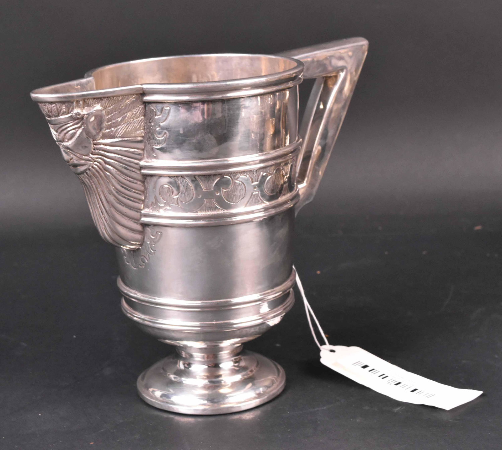 Silver with Unidentified Marks Pitcher: Makers Mark ZN, Circa 1900, banded cylindrical with angular handle and bearden mask below spout, 7-1/4"h, weight approx. 31 T.O. Provenance: Property from the Collection of Myrna and Bernard Posner