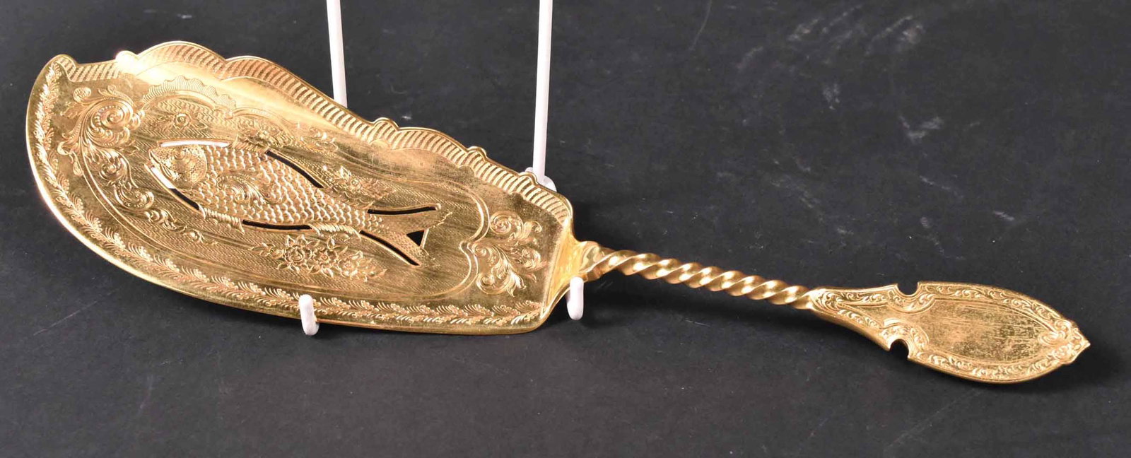 Crosby, Hunnewell, and Morse Fish Server: 19th C. gilt decorated sterling fish server. 12.5"l and apx. 6 t.o. Provenance: Property from the Collection of Myrna and Bernard Posner