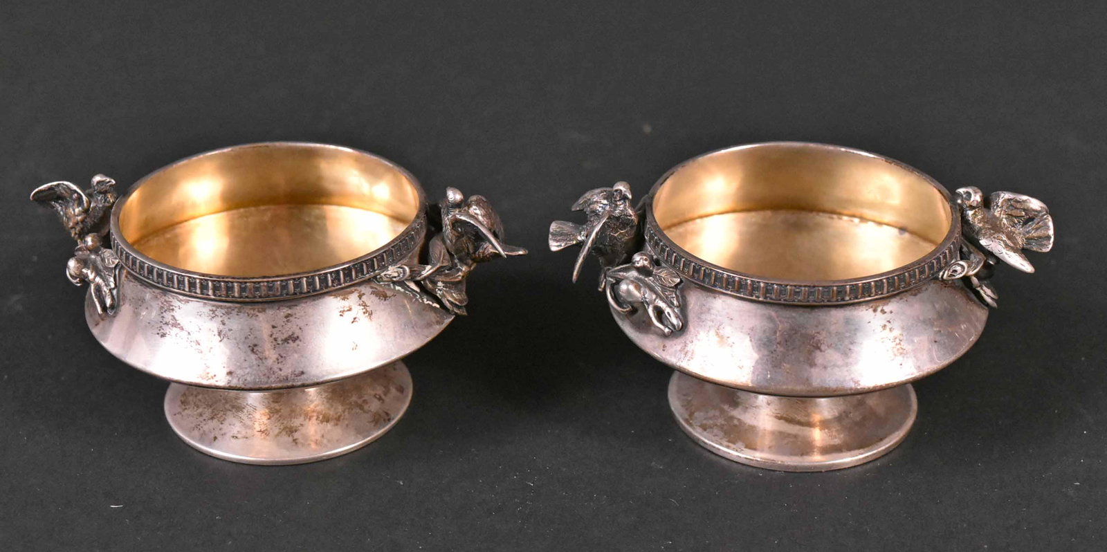Pair Gorham American Silver Salt Cellars: Circular footed, bird on branch handles, 3-1/2"l over handles, weight approx. 5 T.O. Provenance: Property from the Collection of Myrna and Bernard Posner