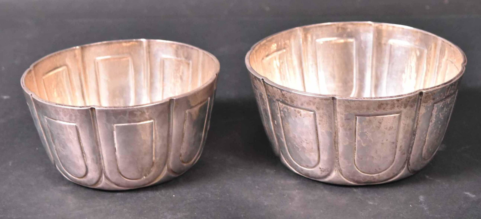 Pair of Edwardian Silver Bowls: Mark of Padgett & Braham, Ltd., London, 1915-1916, circular, the sides chased with lobes. 5"dia. Apx. 16 T.O. Provenance: Property from the Collection of Myrna and Bernard Posner