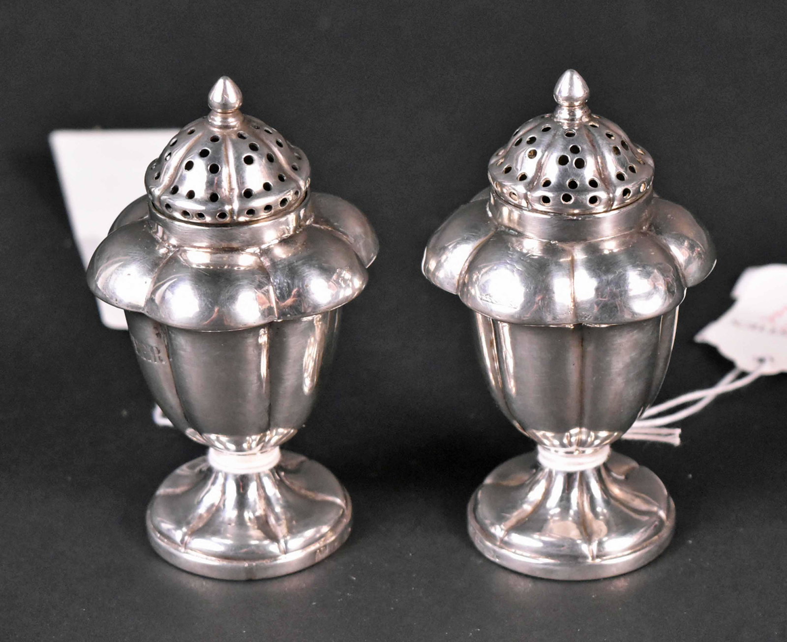 Pair of Indian Colonial Silver Salt & Pepper: Footed lobed body, one engraved "Salt", the other "Pepper", each 4"h, total weight approx. 5 T.O. Provenance: Property from the Collection of Myrna and Bernard Posner