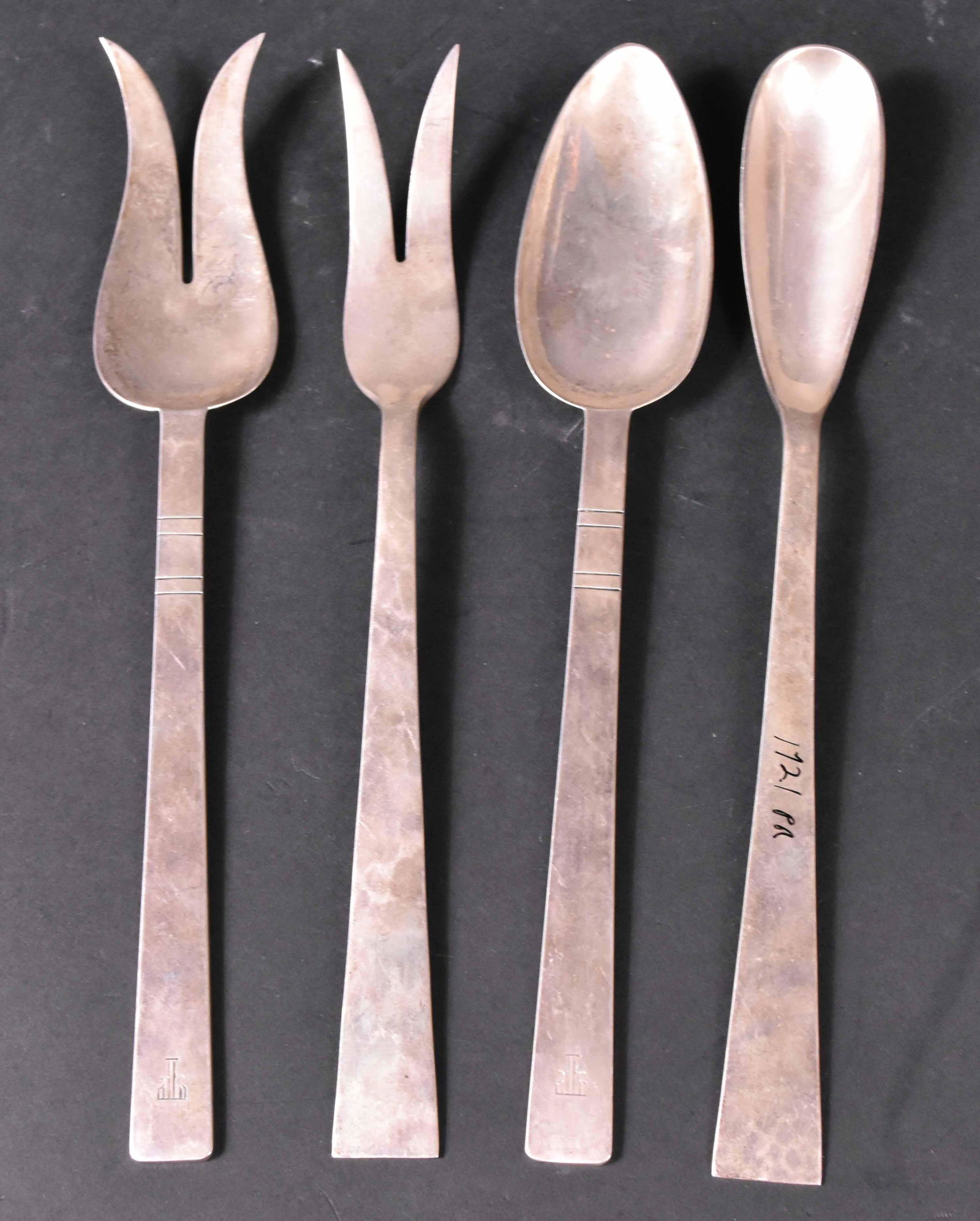 Pair of Silver Pastry Servers and Salad Servers: American, Pastry server and fork with mark of Kalo, Chicago, IL, c. 1920, spot-hammered with upturned pointed terminals, 9-1/4"l. The salad servers with mark of Alan Adler, Pasadena, CA, c. 1950, with
