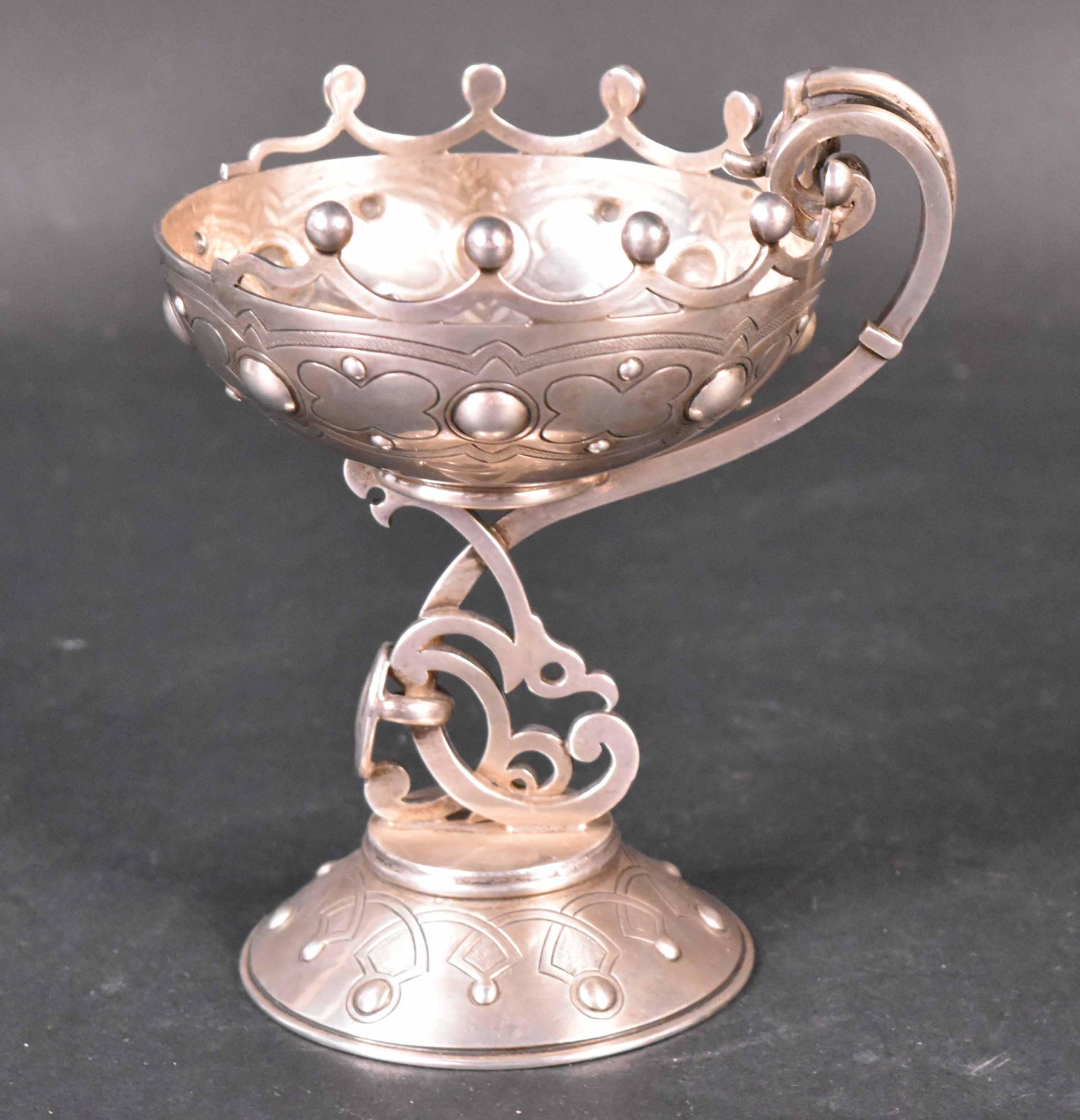 Scottish Silver Chalice, Mark of John Crichton: Crichton & Son, Edinburgh, circa 1900, of circular form with scrolling handle on stylized raised circular base, 3-1/2"high, weight approx. 9 T.O., of circular form with scrolling handle on stylized ra