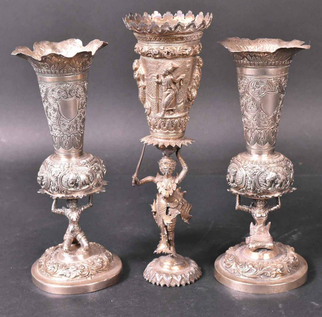 Three Indian Silver Bud Vases: Late 19th C., All raised figural stems, densely chased with figures and foliage. 8-1/2"h Apx. 22 T.O. Bent. Provenance: Property from the Collection of Myrna and Bernard Posner
