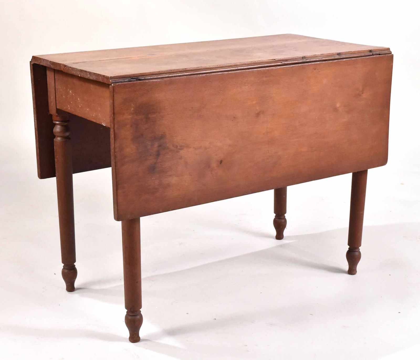 Federal Cherrywood Drop-Leaf Dining Table: American, 1800-1820. Crack through top, some mildew/water damage. 28-1/2"h x 37-1/2"w x 19-3/4"d Provenance: Property from an Ohio Estate.