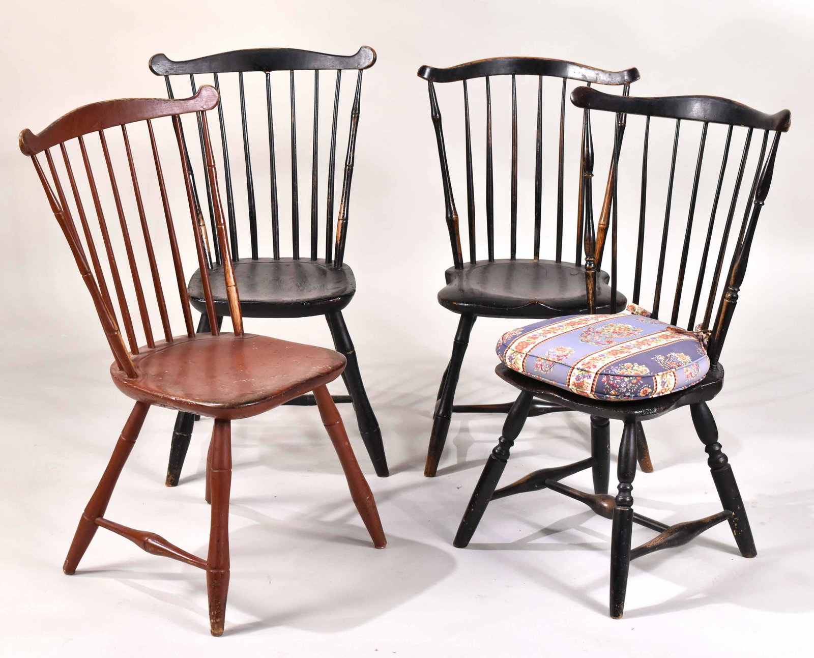 Four Fan Back Windsor Side Chairs: American, each branded, comprising, "Geo Babson," "Fahy," "C. Cavt," and "Brown." Red painted example lacking stretchers. 33-1/2"h, 35"h, 34-1/2", and 35"h Provenance: Property from the Estate of Alic
