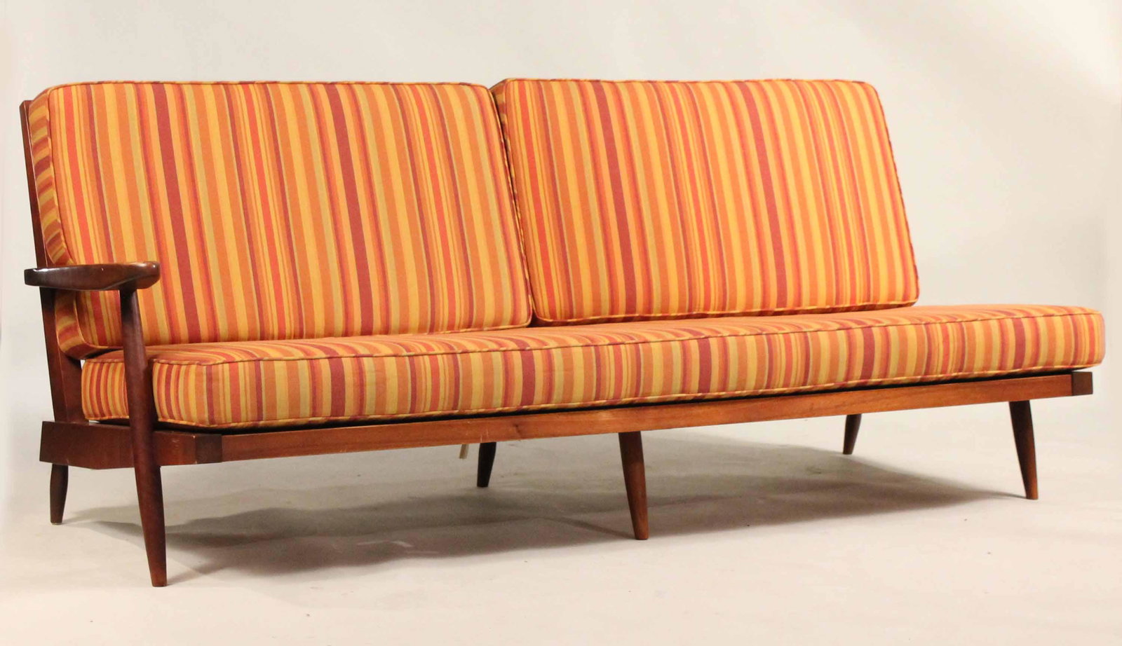 George Nakashima Walnut Sofa: (1905-1990) Nakashima Studio, with copy of original receipt, With spindle back and loose fitted cushions. 31"h x 6'2"l x 30"d Provenance: The Collection of the Estate of Elayne and Monroe Weinstein, P