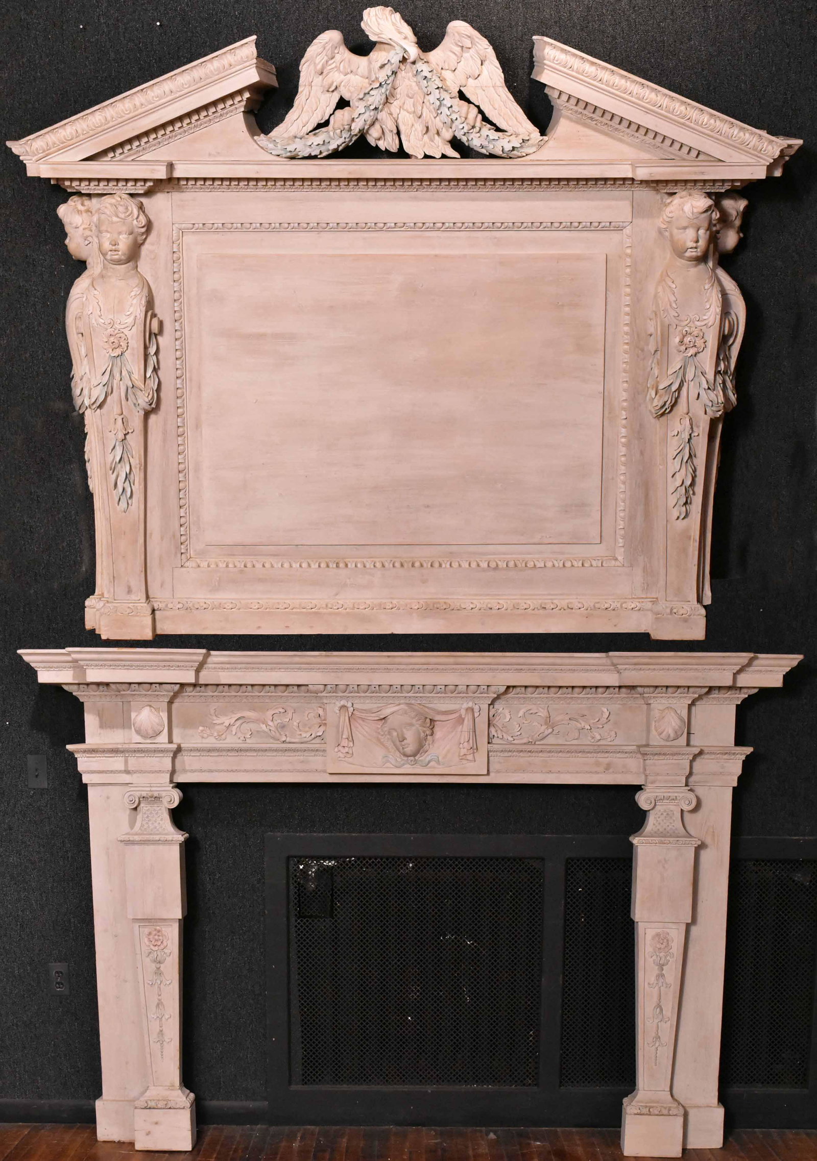 Georgian Style Carved Wood Mantel and Overmantel: 19th/20th C., decorated with putti. Needs repairs to cornice, some losses. Overmantel: 5'8"h x 6'8"w x 12"d Mantel: 5'2"h x 7'8"w x 13-1/2"d Provenance: Property from an Ohio Estate.
