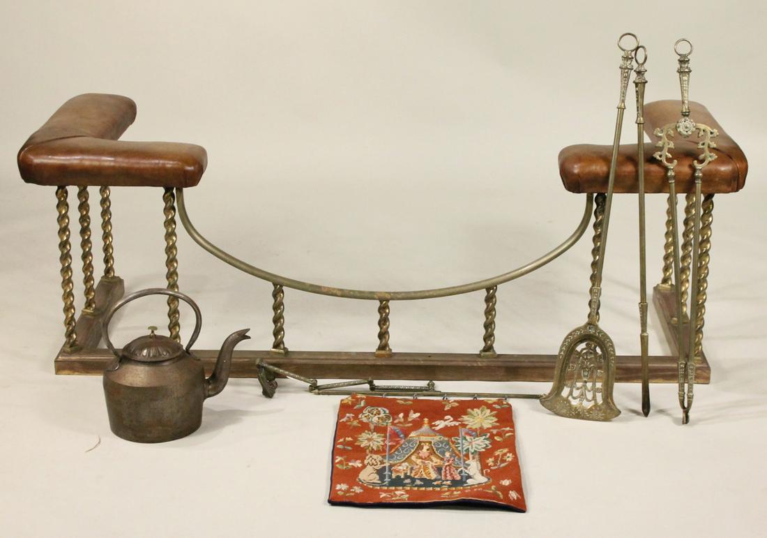 Victorian Brass and Leather Club Fender: English, late 19th C. Together with a kettle, three matching brass firetools, shovel, poker and tongs, and a needlepoint tapestry. 6 pieces 21"h x 5'3"w x 22-1/2"d
