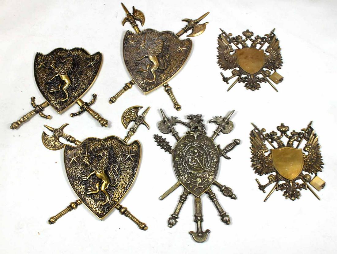 Six Shield-Form Cast-Brass Wall Plaques: Late 20th C. including three with rampant lion. Some elements lacking. 27"h x 17"w Provenance: Property from an Ohio Estate.