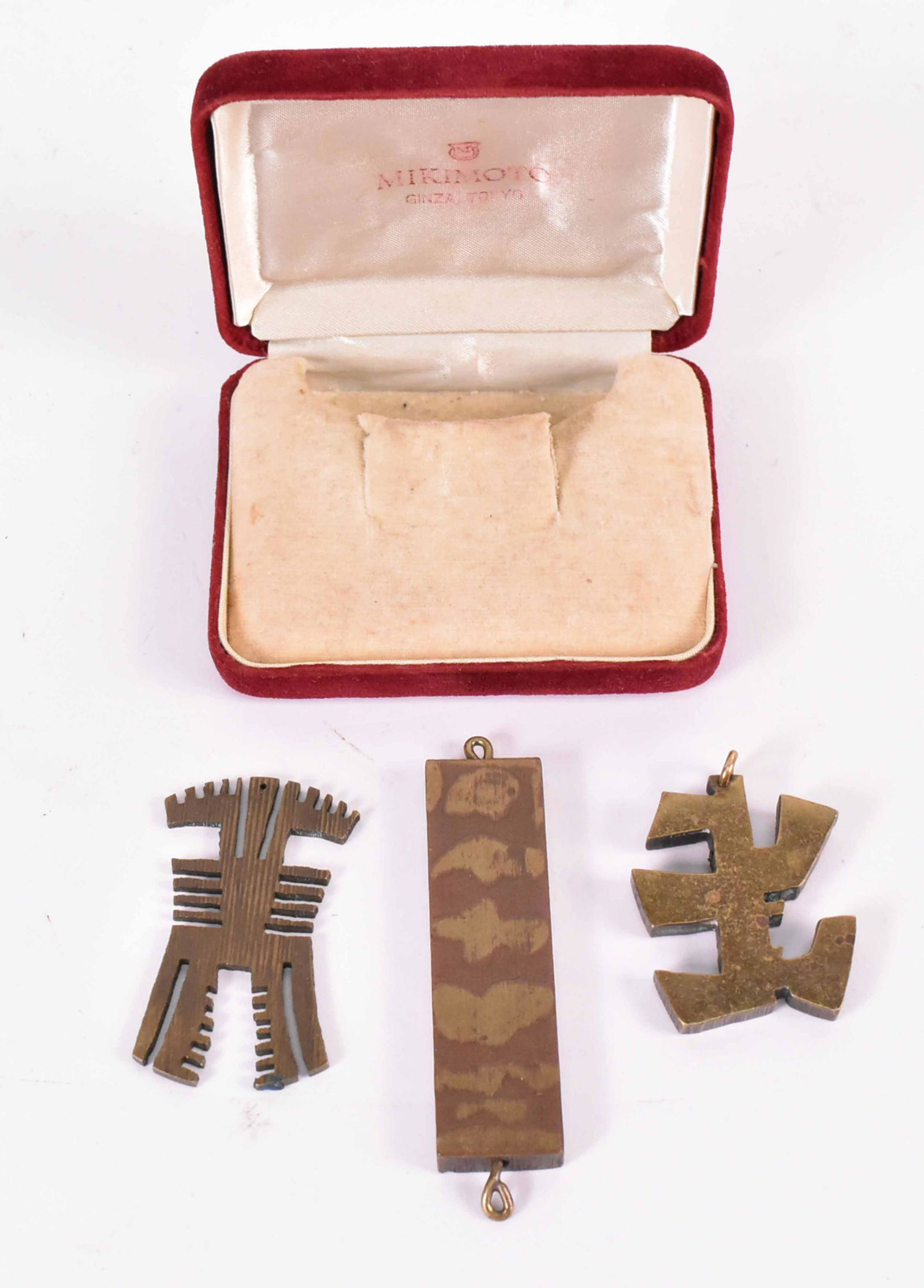 Three Mixed Metal Pendants, Robert Watts: (American, 1923-1988) made for the consignor Letty Lou Eisenhauer. 1-3/4"h x 1-1/2"w, 2-1/8"h x 1-1/8"w, and 3-1/4"h x 3/4"w Provenance: Property consigned by Letty Lou Eisenhauer (born 1935). She was