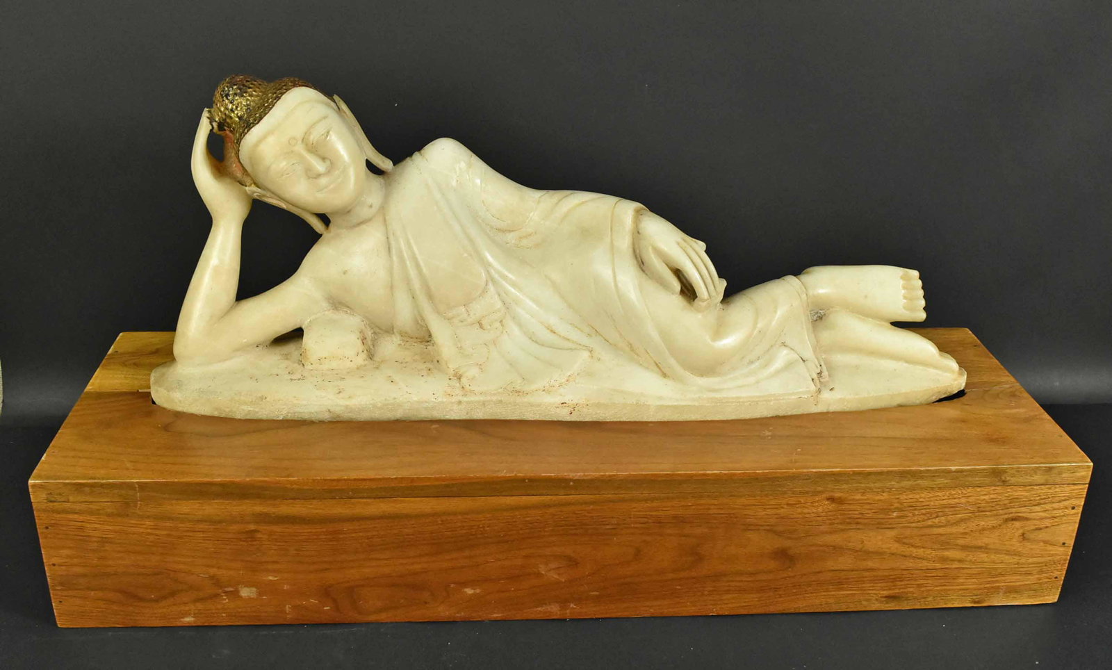 Thai Carved Marble Reclining Buddha: 19th C., on wood base. 17-1/2"h x 36"w x 12"d, overall. Buddha: 11-1/2"h x 30"l