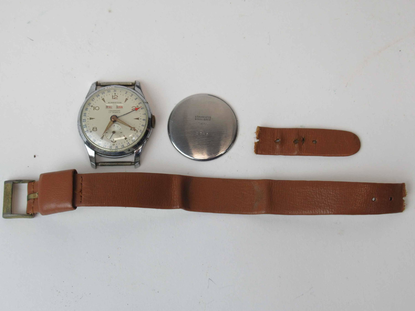 Kingston Gentlemen's Wrist Watch: Kingston Gentlemen's Wrist Watch with calendar, seventeen jewels, Swiss made, stainless steel back 1240, used condition, wear, worn, unknown working condition, approximately 1" dial diameter.